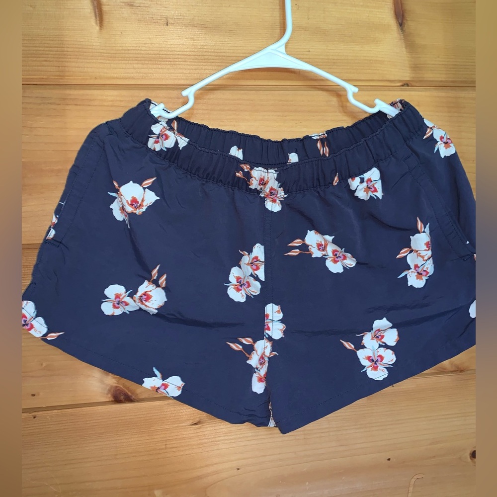 Patagonia Navy Blue Shorts with White and Pink Flowers.